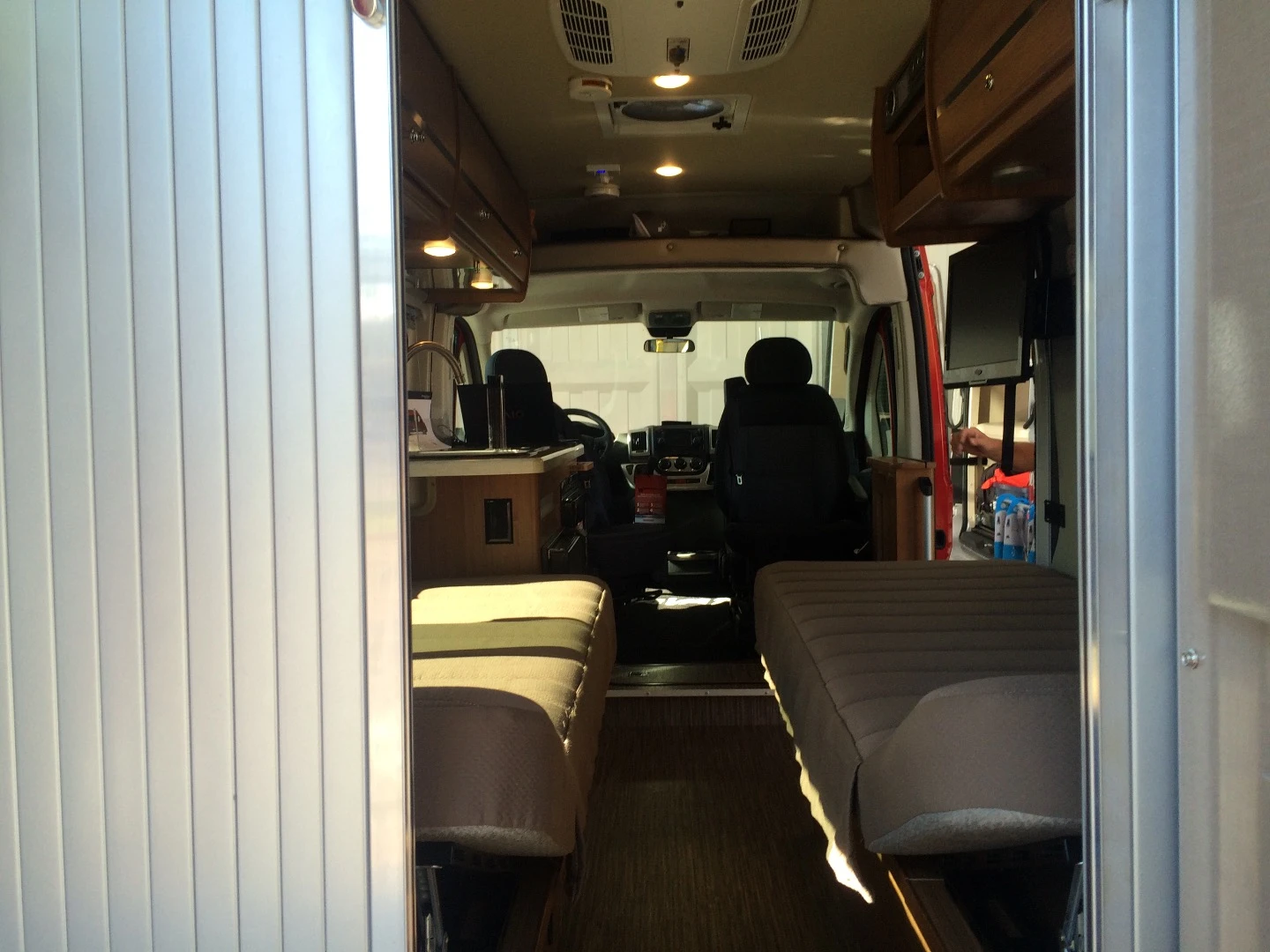 The newest Travato layout keeps things open with two single side beds