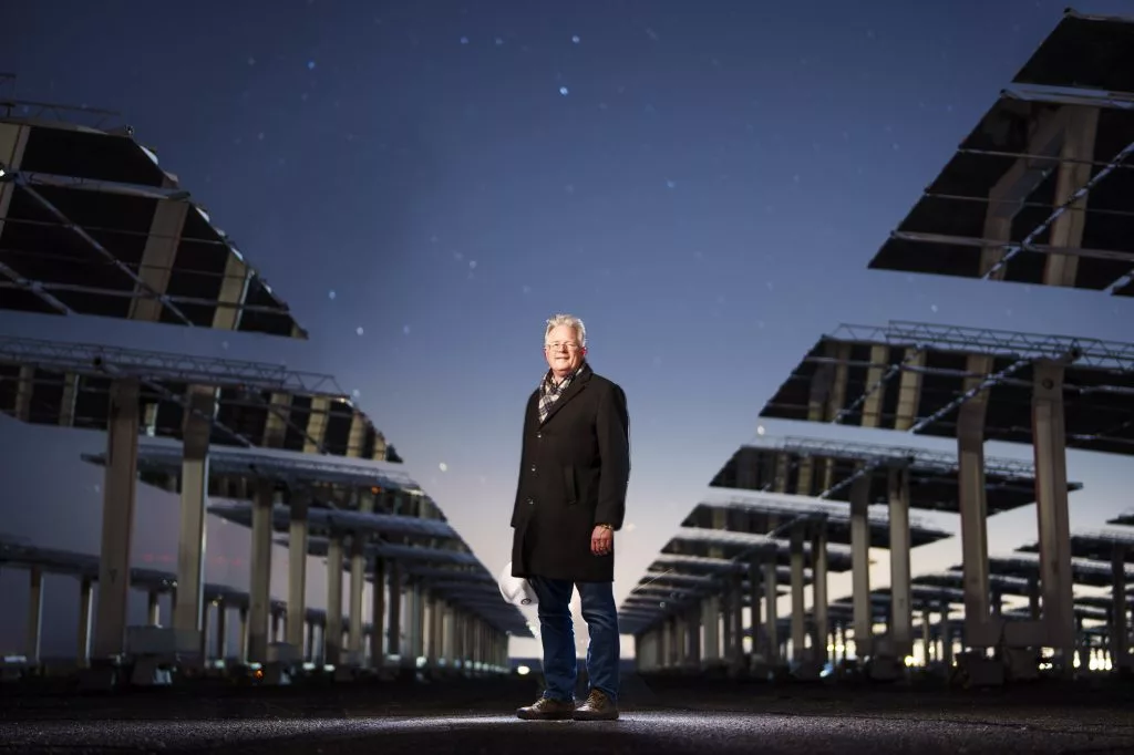 John Sandusky standing among the heliostats
