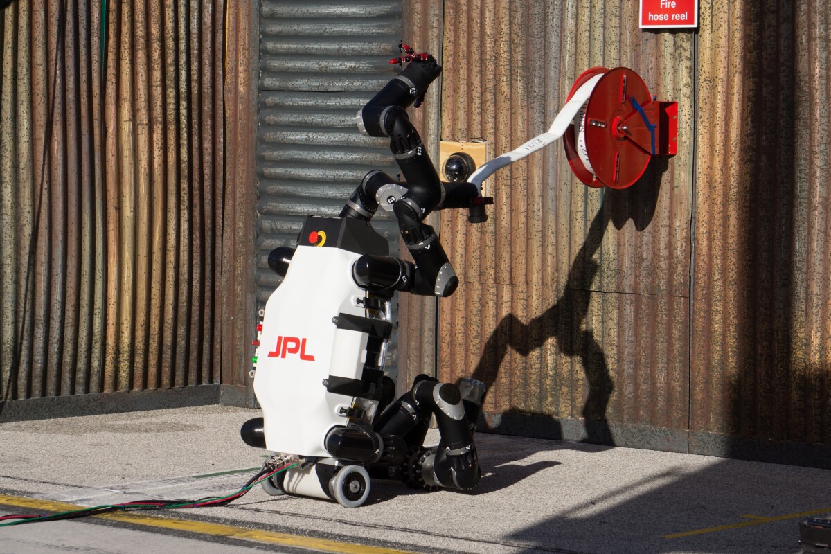 RoboSimian carrying a fire hose