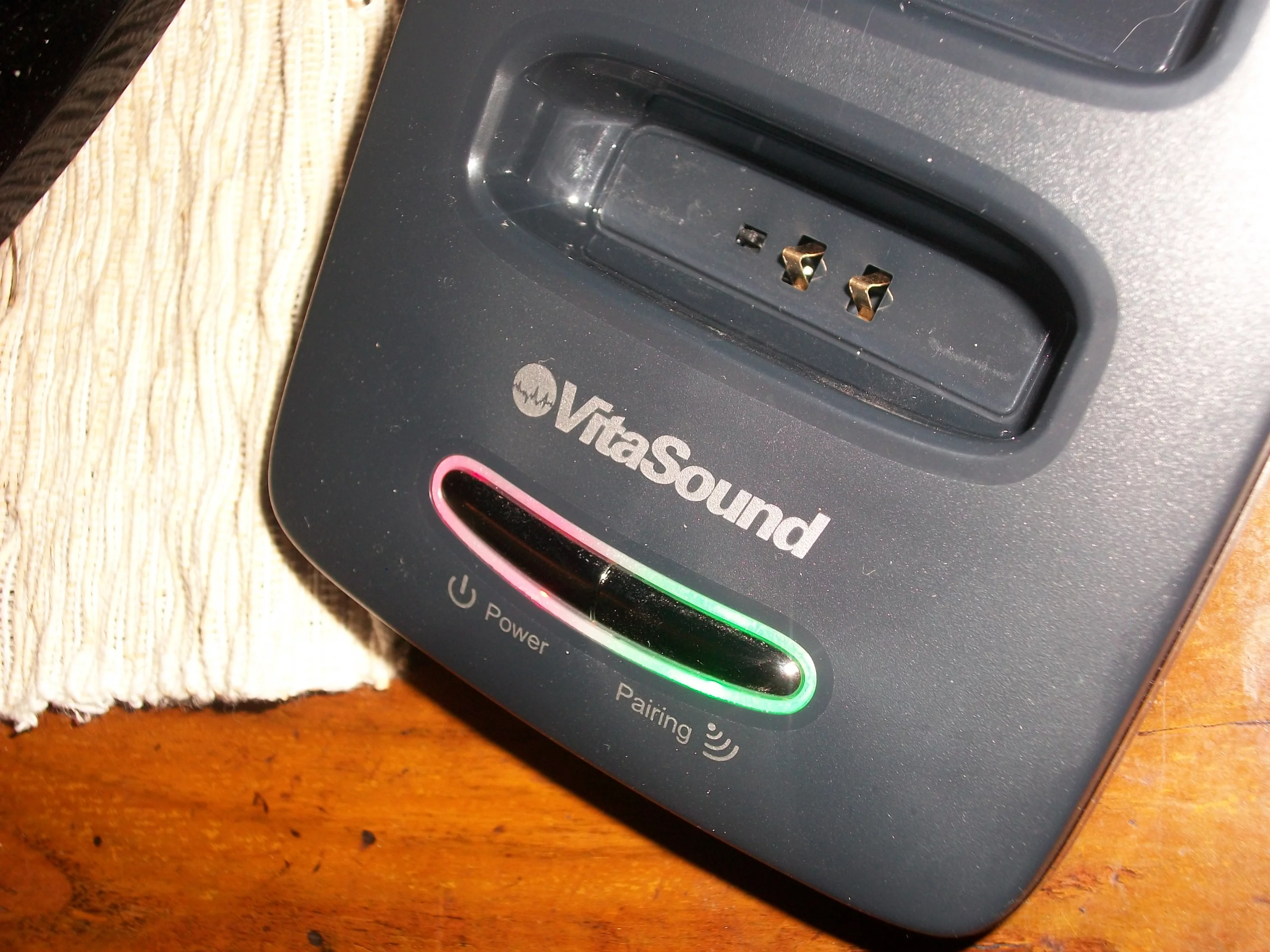 The LED around the wireless pair button turns from flashing to solid green, which indicates that an audio signal from the TV had been detected