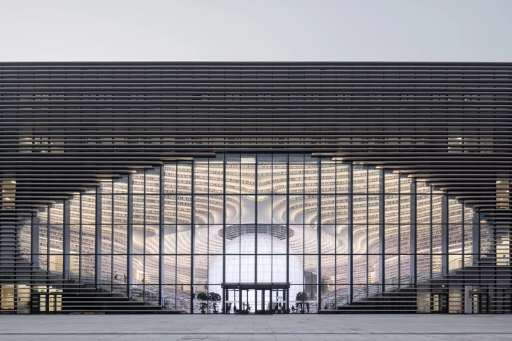 The undulating shelves blur the outside and inside of the Tianjin Binhai Library