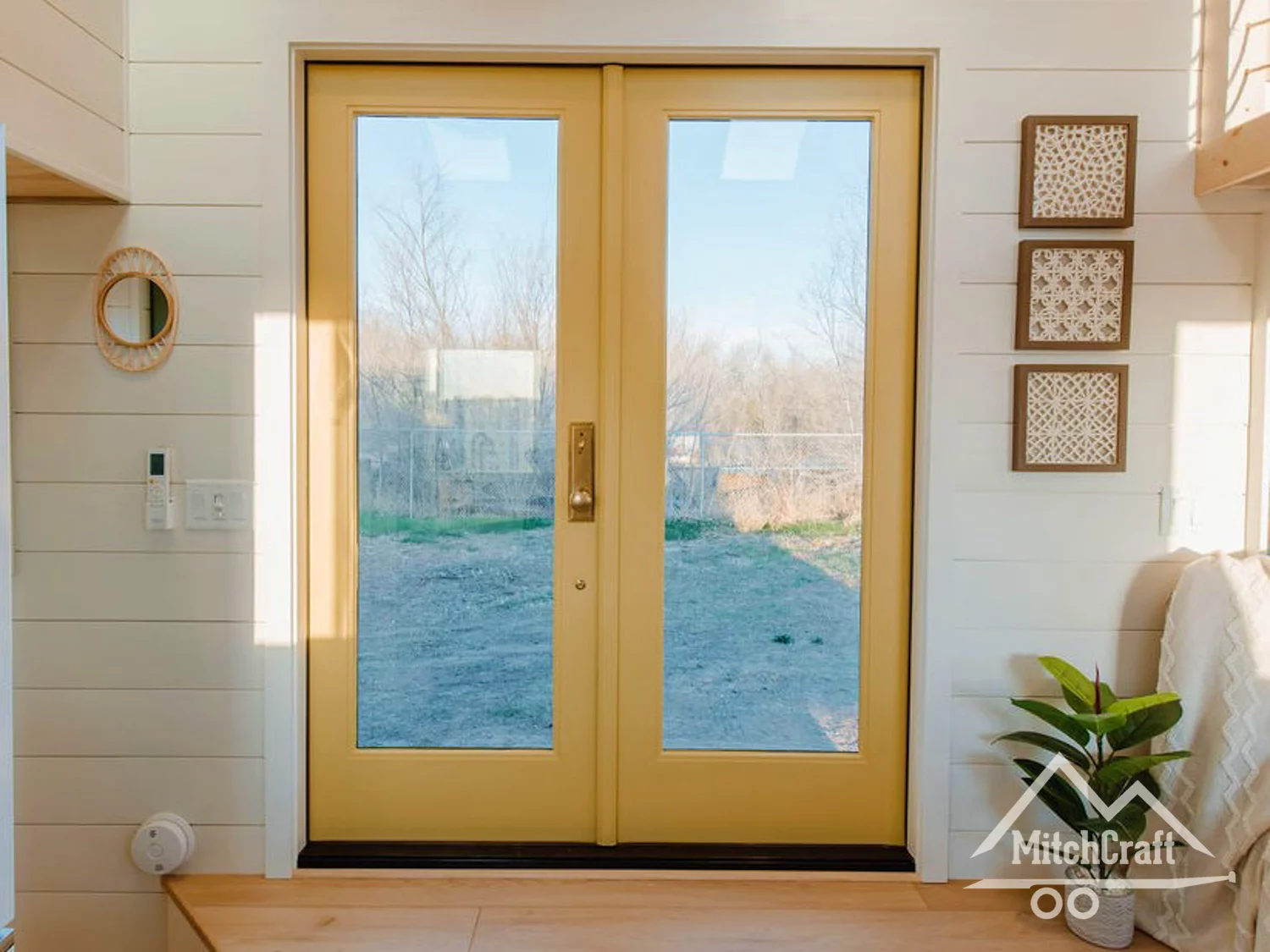 Double glass doors serve to open up the home to the outdoors