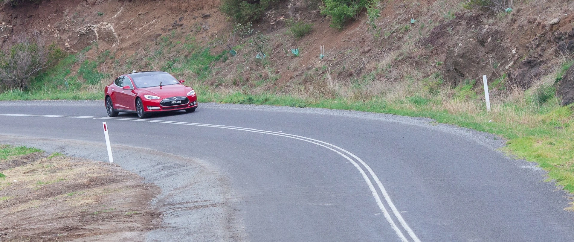 The air suspension on the Model S handles mid-corner bumps well, and doesn't get deflected easily off line
