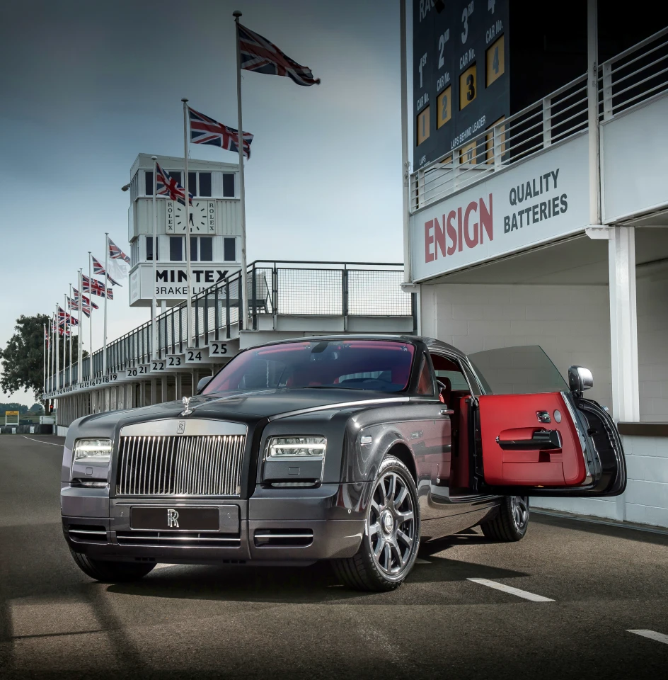 The exterior features gunmetal paint with black around the hood and windshield frame