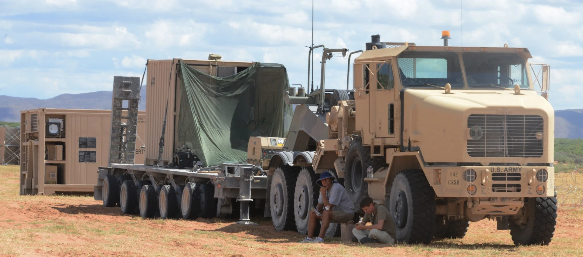 A heavy equipment transporter gets the container system out to the expeditionary base camp on Fort Bliss, Texas