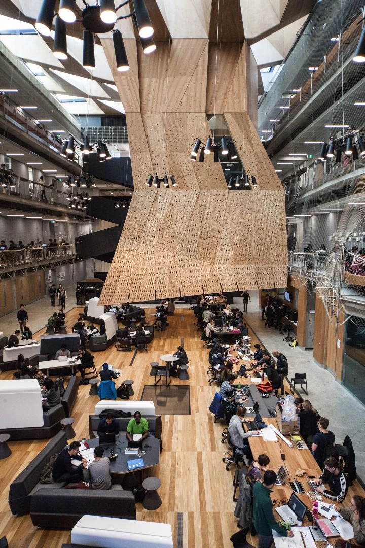 The building's centerpiece is a stalactite-like structure that houses three studio spaces stacked on top of one another