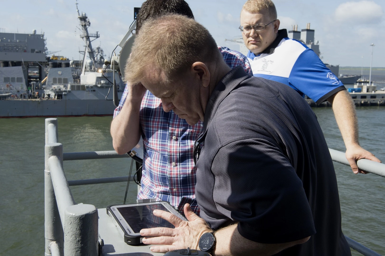 Scott Lowery from Naval Surface Warfare Center Panama City, sets up the Office of Naval Research (ONR) TechSolutions-sponsored Flashing Light to Text Converter (FLTC) aboard the guided-missile cruiser USS Monterey (CG 61) prior to a pierside demonstration