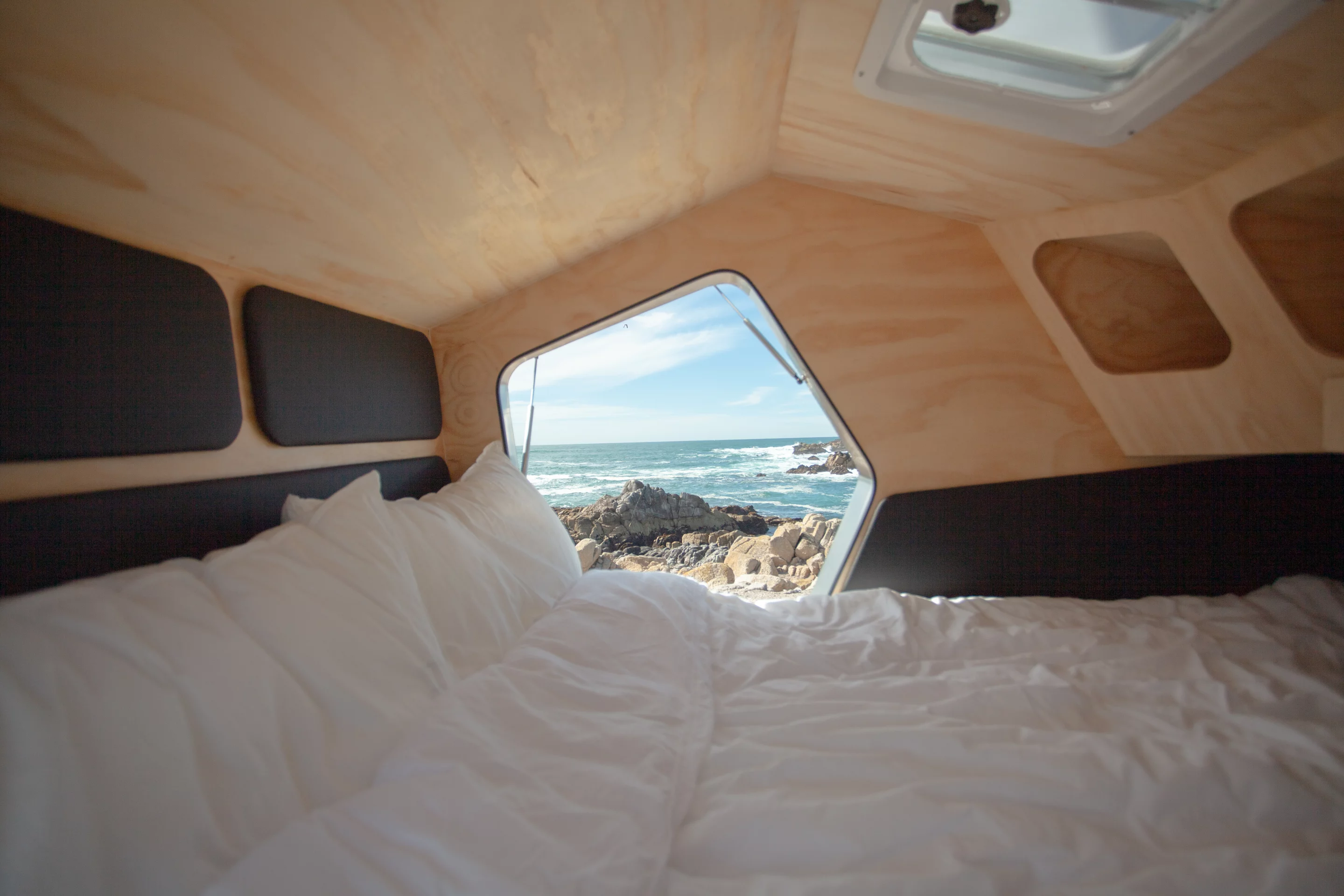 The Polydrop cabin has a mattress, storage shelves, LED lighting, an electrical control center and a roof vent