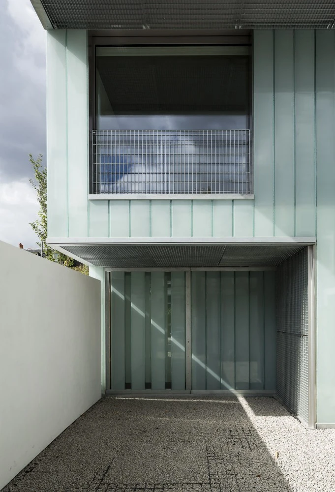 Slip House incorporates sustainable technologies like a rainwater harvesting tank, solar panels, and a solar-powered ground-source heat pump