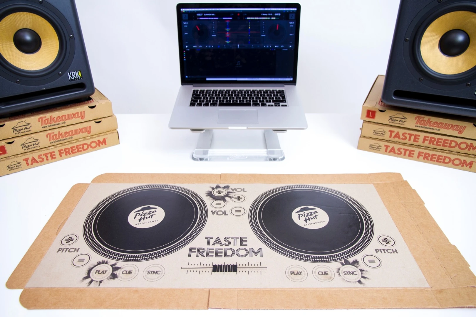 The printed circuitry is modelled on a modern DJ setup, with two turntables, a crossfader, pitch controls, cue buttons and the ability to sync music