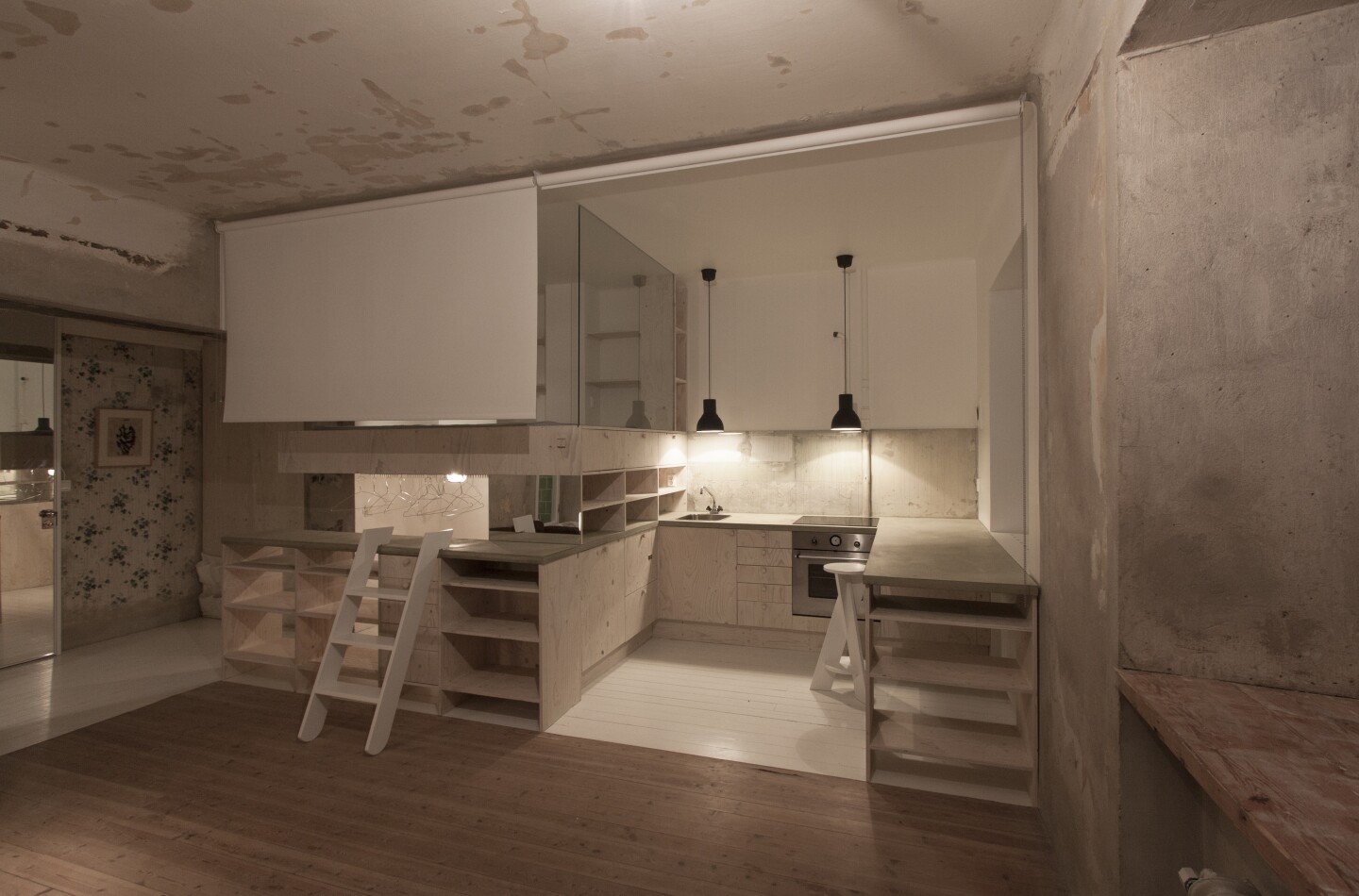 Glass panels are used to separate the kitchen/bed/wardrobe spaces from each other