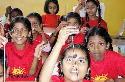 Indian children playing with one of Arvind Gupta's scientific toys, that they made themselves