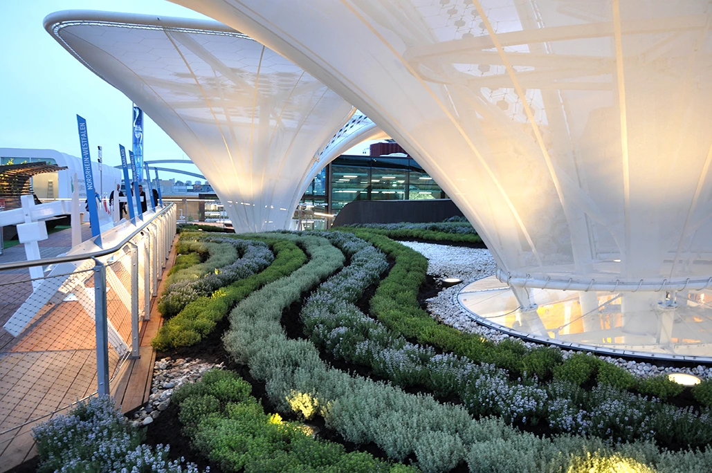 The pavilion features rolling curves, large green canopy and huge solar trees