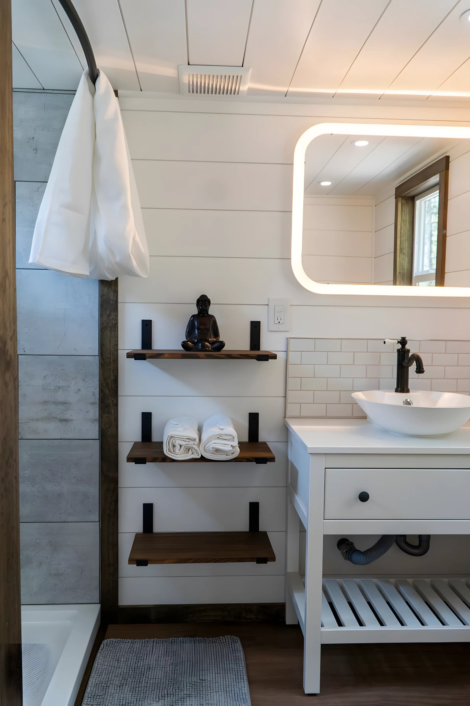 The Olympic's bathroom is quite compact and includes a vanity sink, shower, and composting toilet