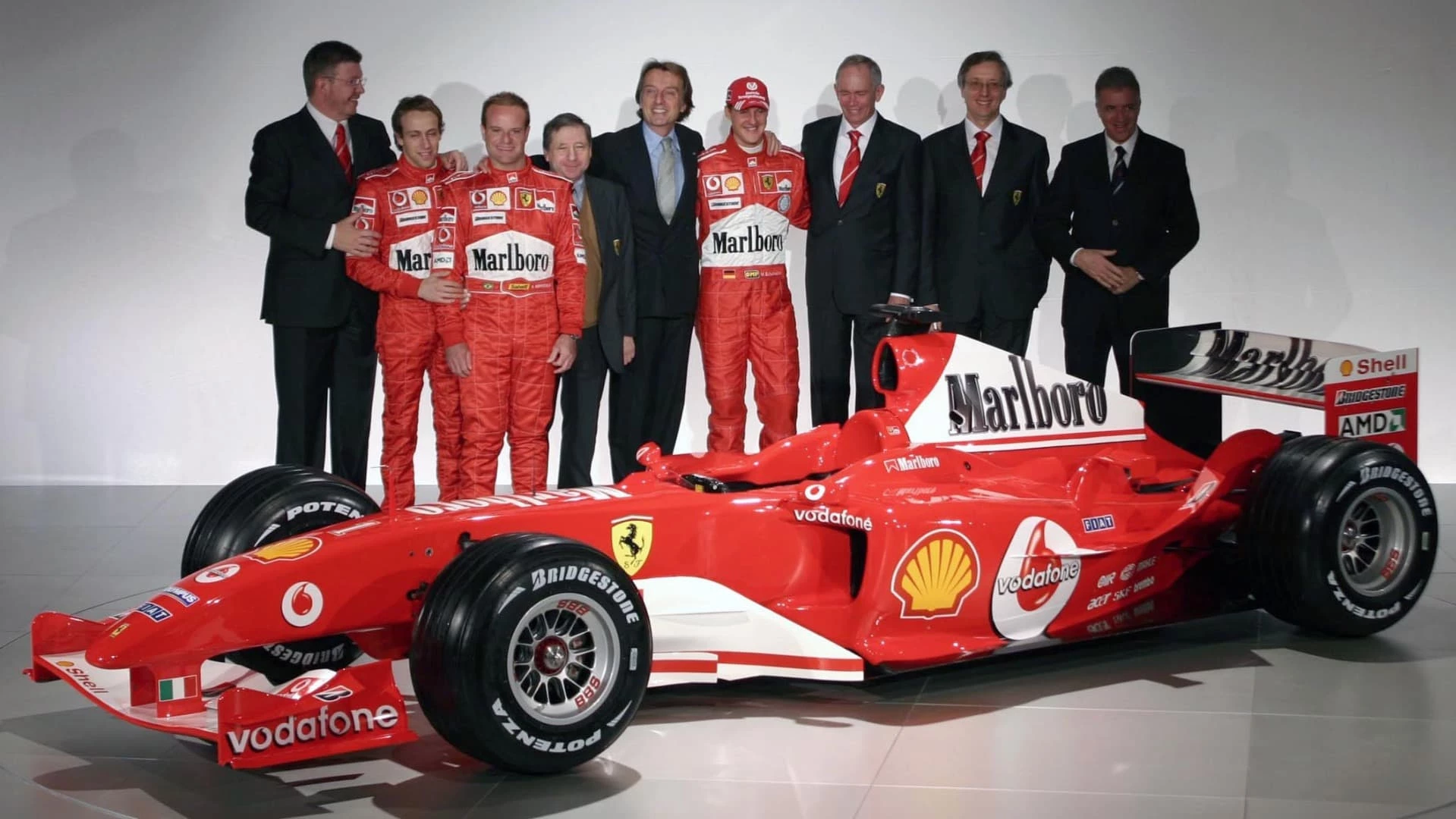 Another dream team of talent at the launch of the F2002: Ross Brawn (a key role in eight 8 constructors' championships and 8 drivers' championships including subsequently his own championship-winning team), reserve driver Luca Badoer, Rubens Barrichello, Jean Todt (a key role in four WRC championships, four Paris-Dakar wins, two Le Mans 24 Hour wins, and 14 F1 Titles and now FIA President), Ferrari Chairman Luca di Montezemolo, Michael Schumacher, F2002 designer Rory Byrne (whose cars have won 99 Grands Prix, seven constructor titles and seven drivers titles), Paolo Martinelli (head of Scuderia Ferrari Engine Department from 1994 to 2006), and then Fiat Chairman and CEO, Paolo Cantarella.