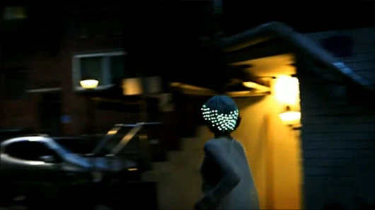 A model dashes through the night wearing Gravity of Light, a 3D-printed hat with embedded electronics created by Younghui Kim and Yejin Cho