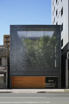 The glittering facade and small scale contrast with the high tech wide avenues that has characterized the reconstruction of Hiroshima (Image: Hiroshi Nakamura & NAP)