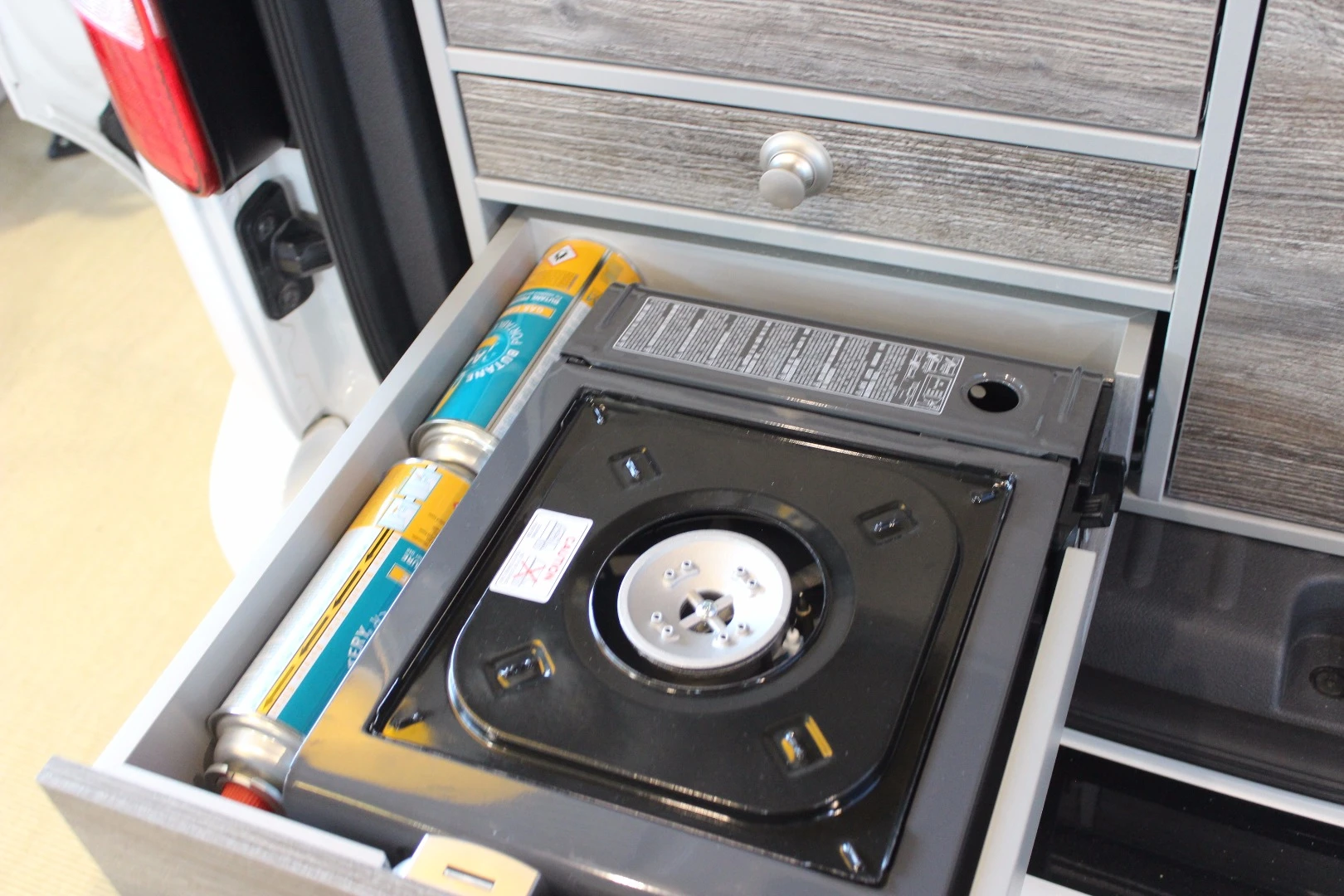 Single-burner canister stove in the VanEssa-converted VW Caddy