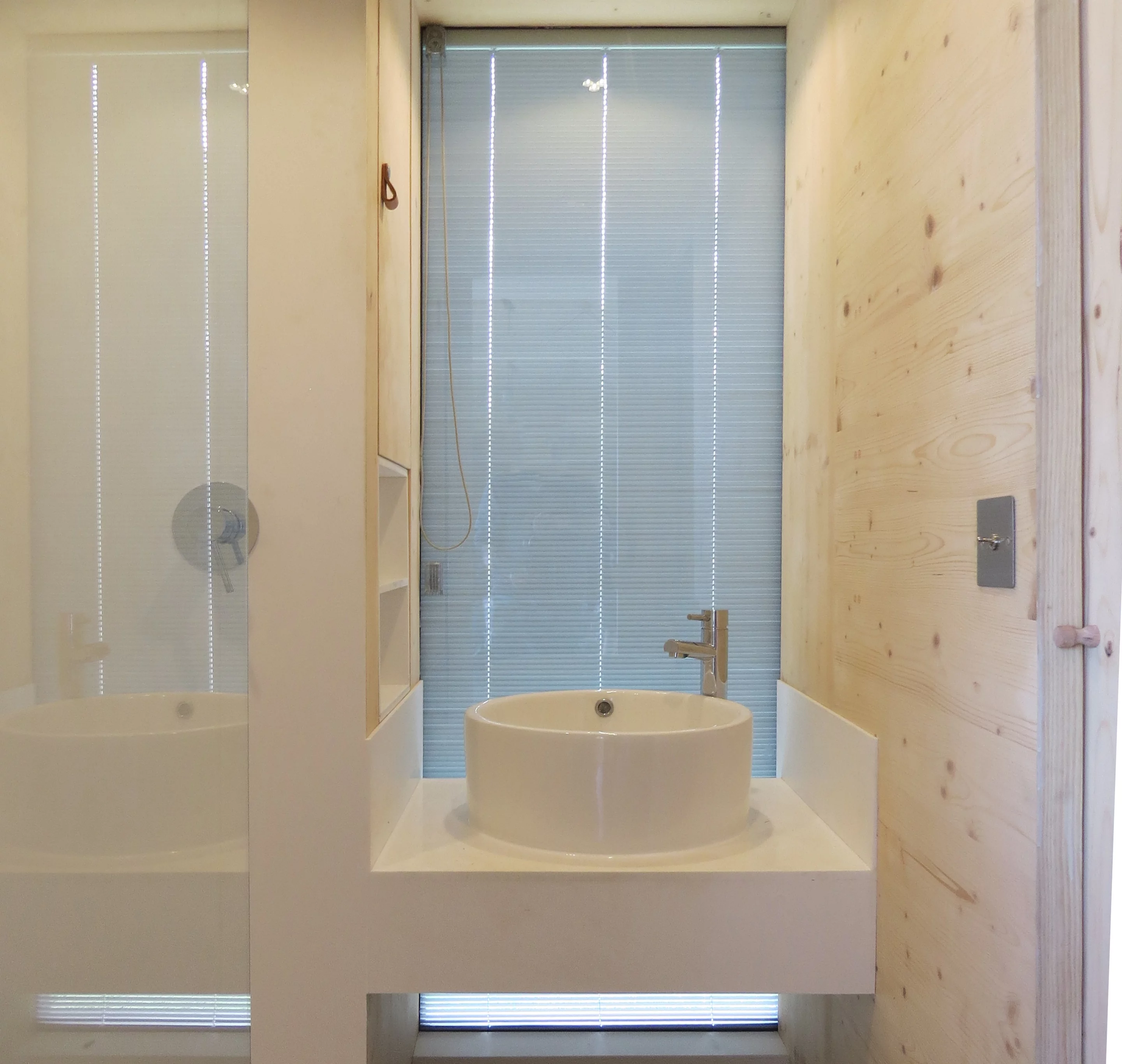 The Long Shed's bathroom includes a shower, sink, and composting toilet