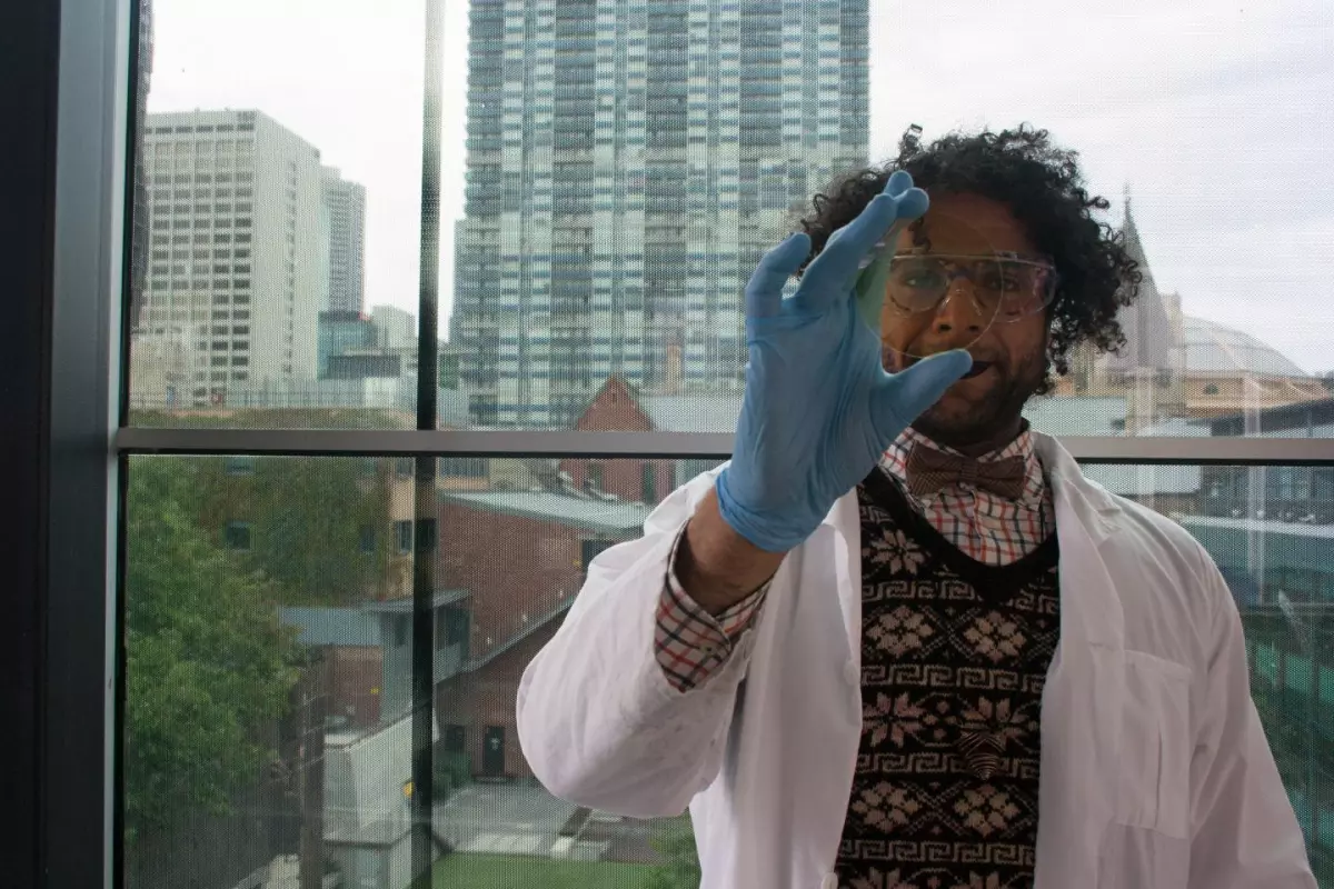 PhD student Mohammad Taha with a sample of coated glass
