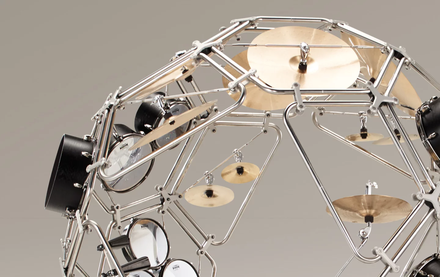 The Raijin drum kit is spread out over the inside of a huge hamster ball made of metal tubing