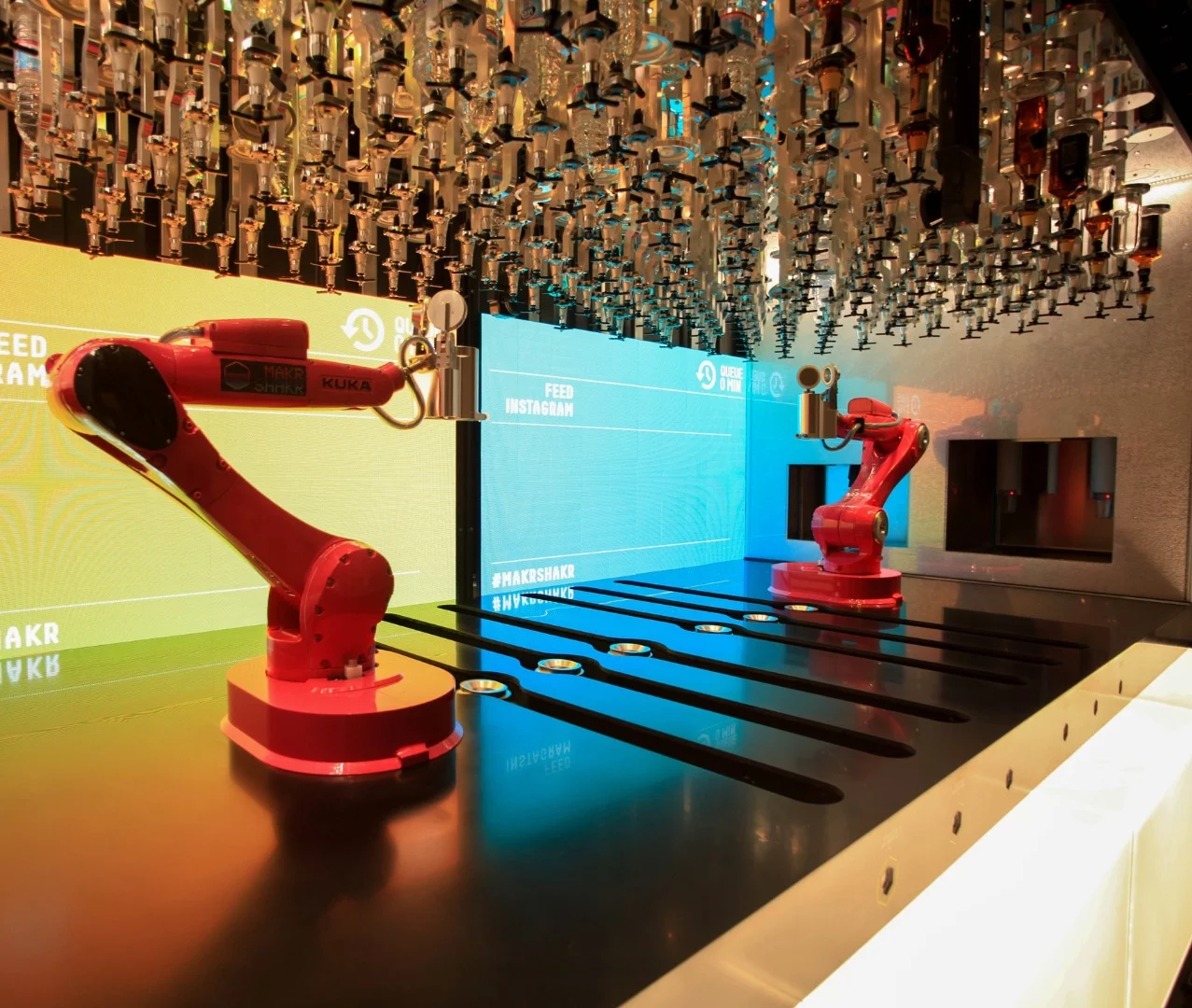 The robots access a selection of ingredients mounted above them