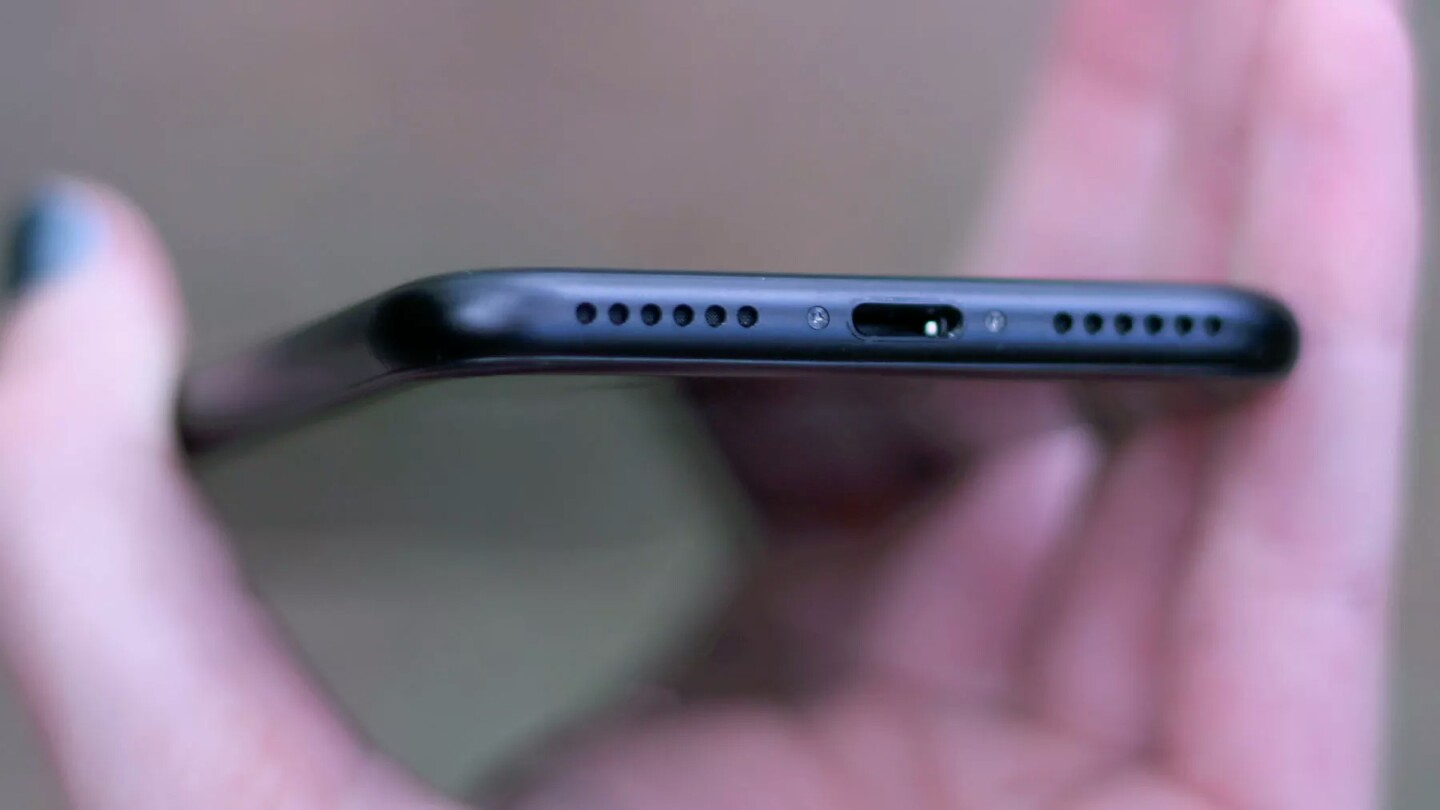 No headphone jack, just two symmetrical grilles on either side of the Lightning port