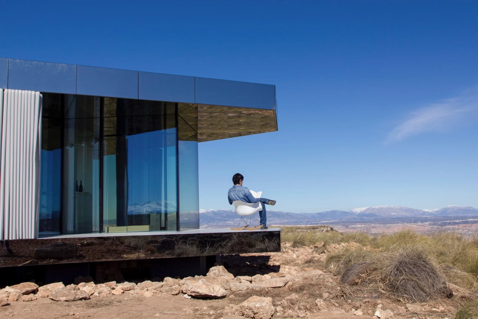 The Glass House offers its occupants amazing views of the rugged desert-like Spanish landscape