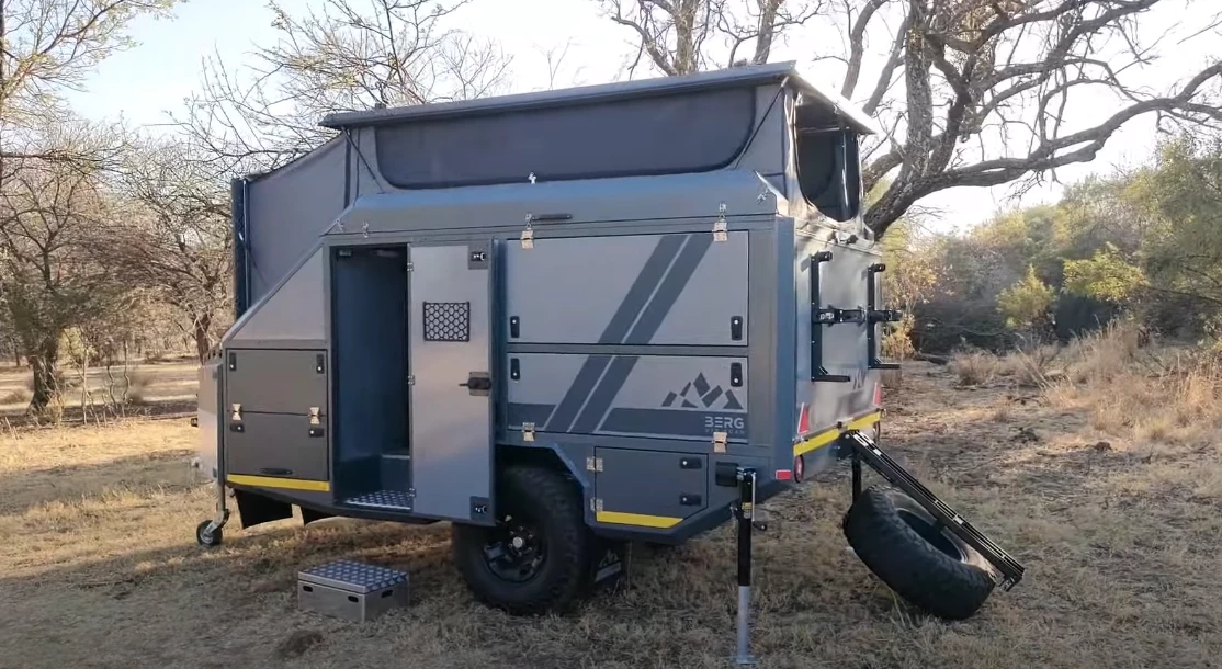 To start setup, the owner drops down the strut-assisted tire holder and then lifts the strut-assisted pop-up roof