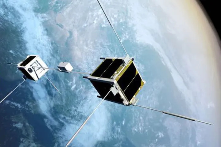 An artist's conception of the STARS-Me satellites, two CubeSats connected by a tether with a robot that climbs between them
