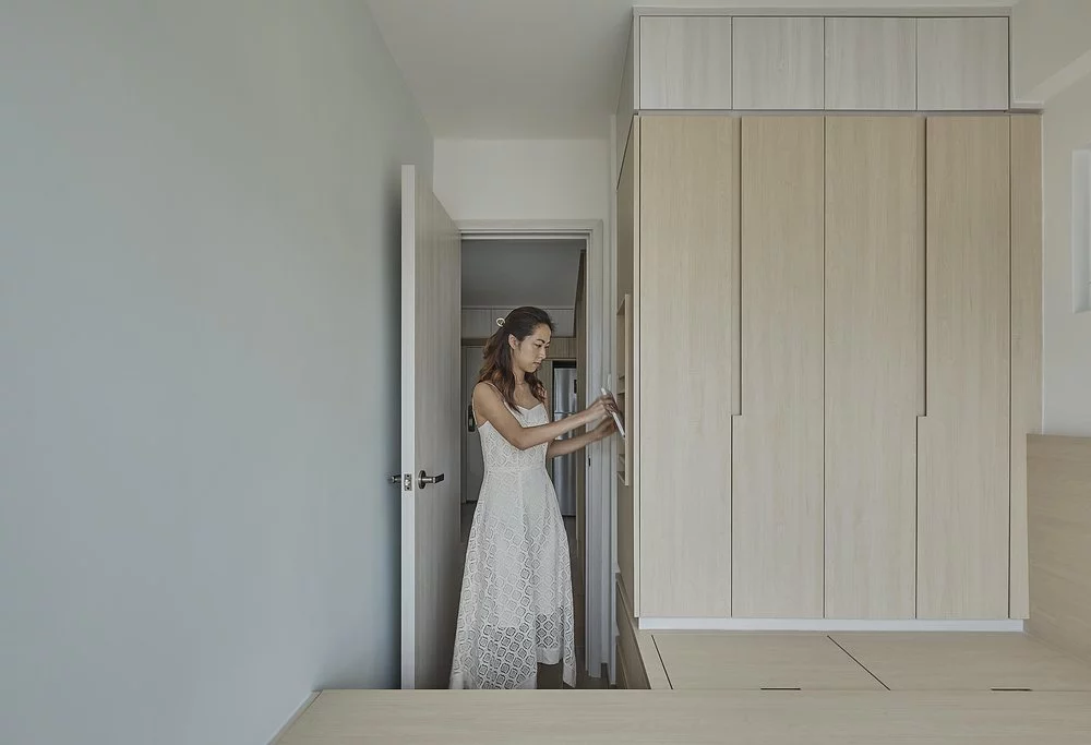 The master bedroom features a plethora of storage, boasting a wooden platform filled with hidden storage boxes