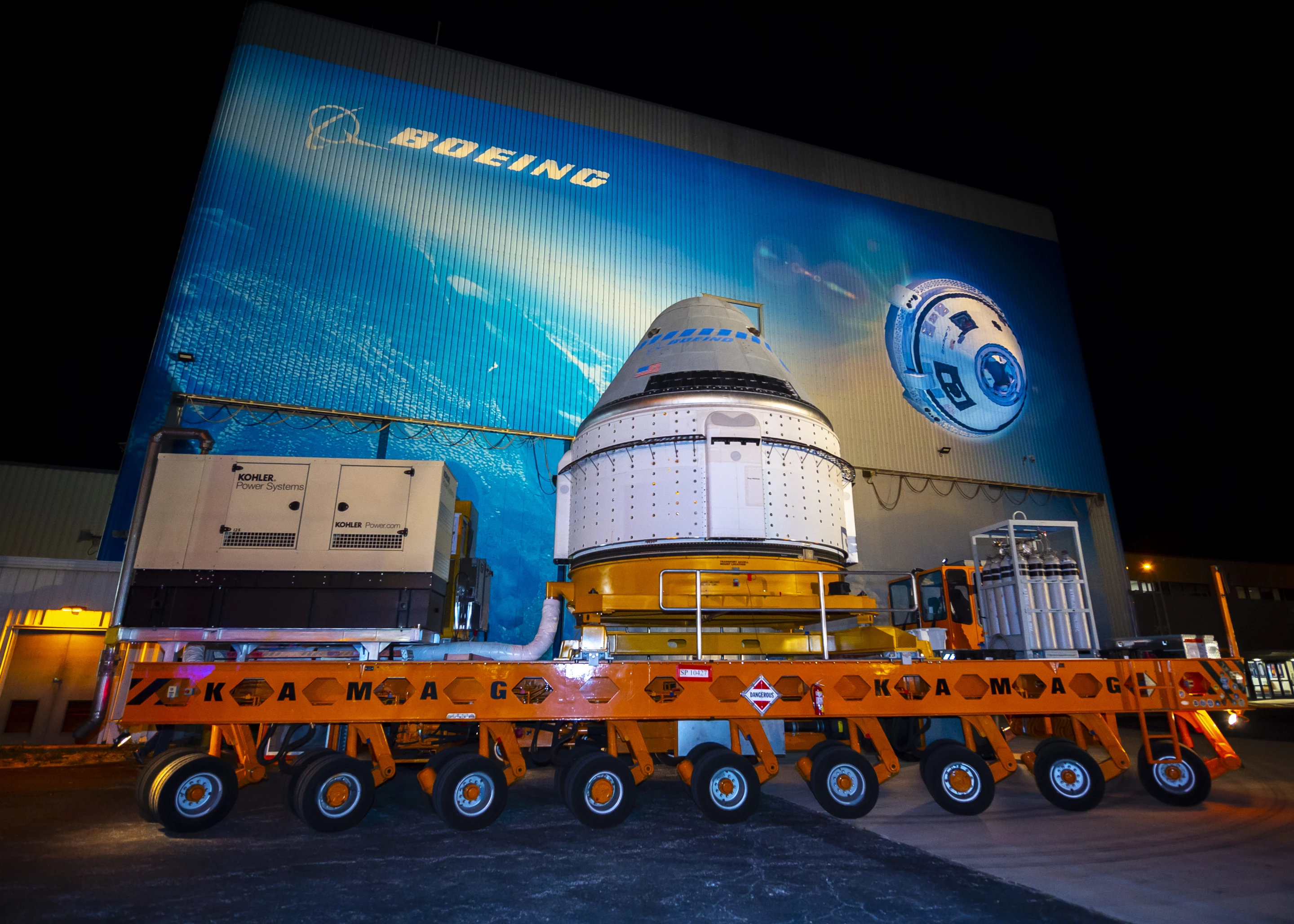The Boeing CST-100 Starliner spacecraft rolls out from the company’s Commercial Crew and Cargo Processing Facility at NASA’s Kennedy Space Center in Florida