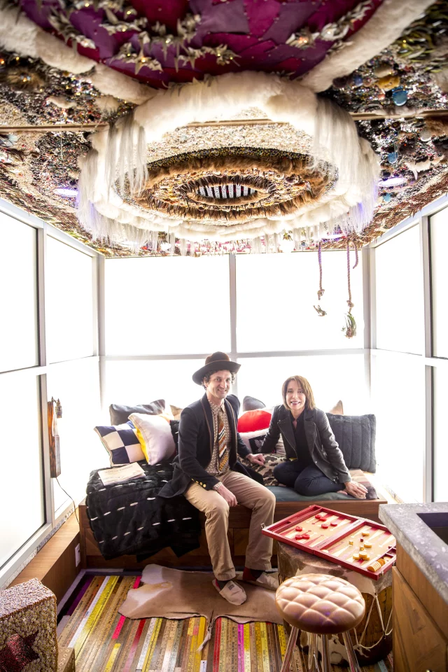 SCAD alum and featured artist Marcus Kenny sitting in SCADpad North America with SCAD president and co-founder, Paula Wallace (Photo: SCADpad)