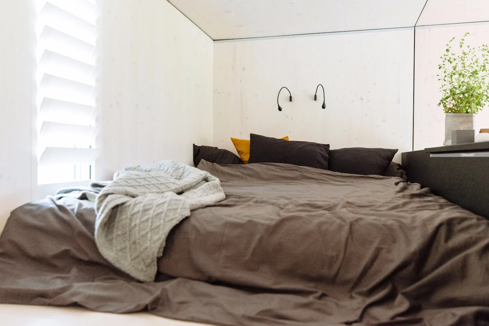 Stairs lead to a small bedroom area