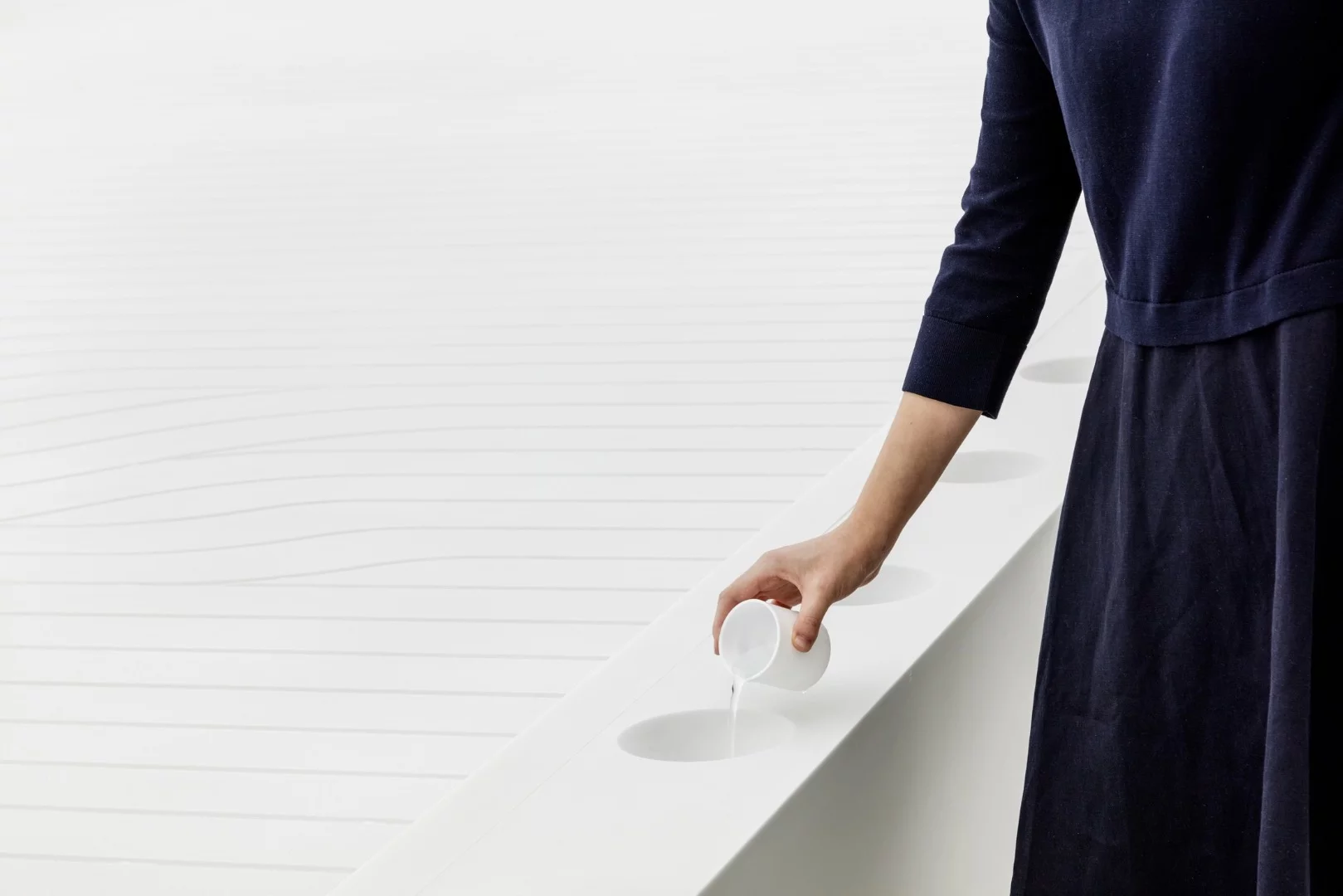 The water installation inside uses water droplets to create a visage resembling the sight of a giant city from space