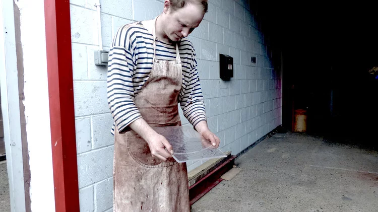 Alex Chinneck checking out the wax glass used for the windows (Photo: Tommophoto)