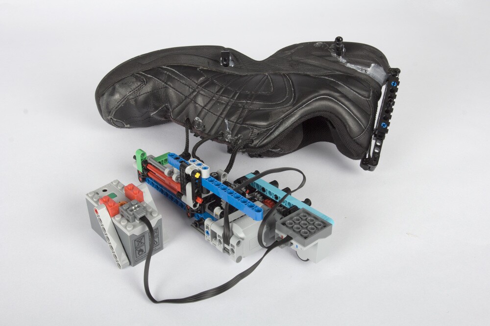 The Lego winding mechanism of the self-lacing shoe hack can be attached, removed and modified