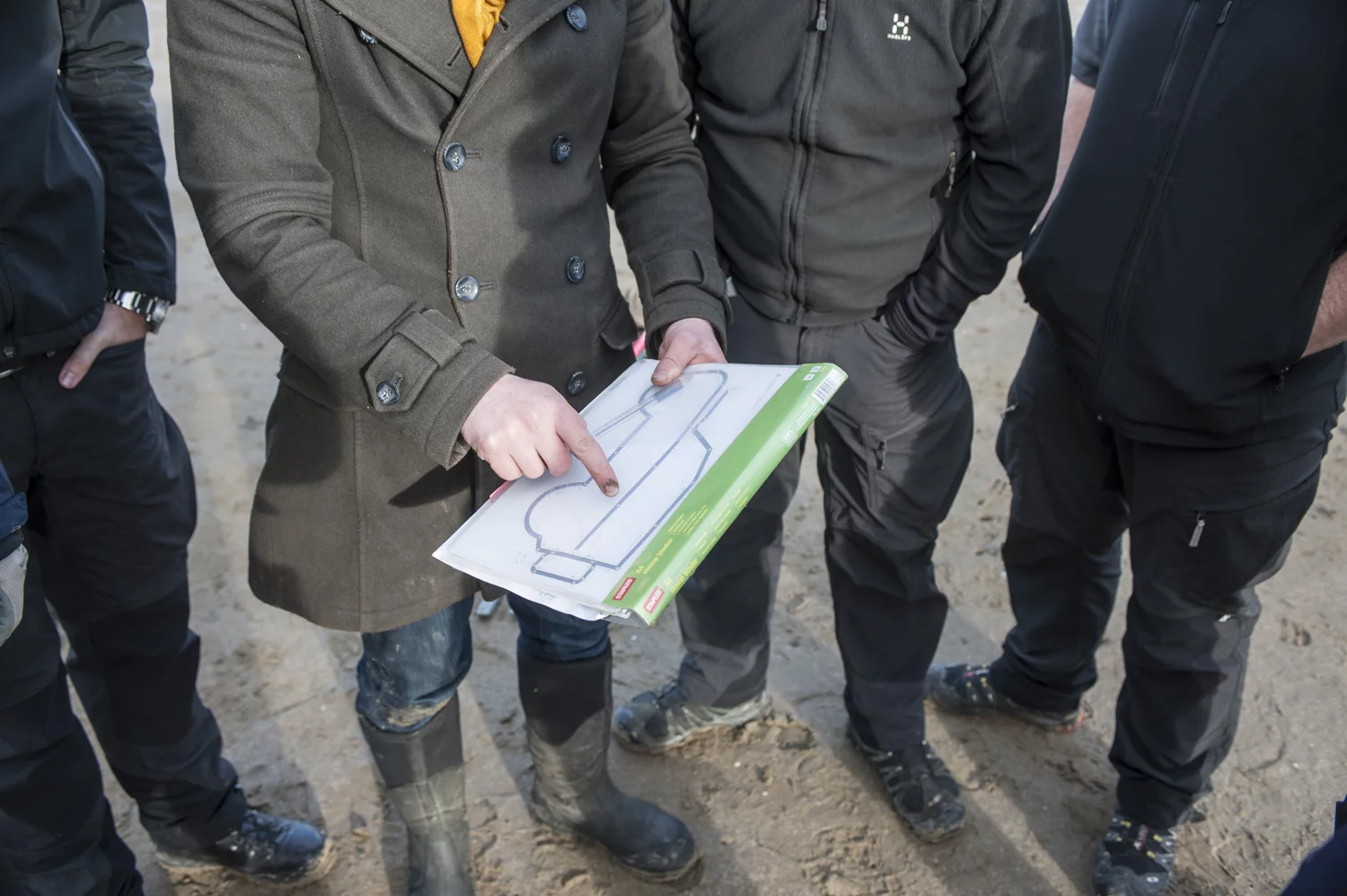 The team prepares for their vehicular-brushed drawing