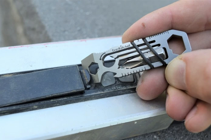 The EverRatchet multitool at work opening a battery compartment
