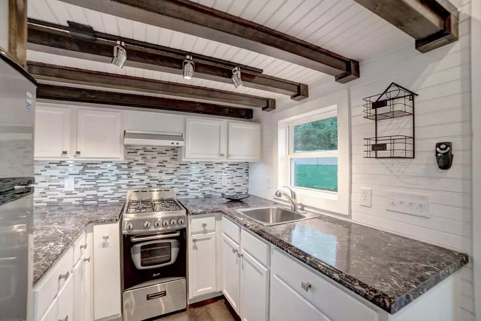 The U-shaped kitchen looks like it includes plenty of cabinets and counter top space