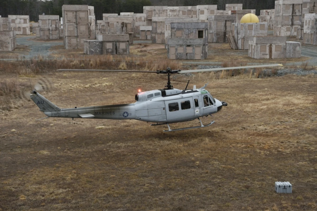 A UH-1 Huey equipped with an AACUS autonomy kit makes an approach for landing during final testing at Marine Corps Base Quantico