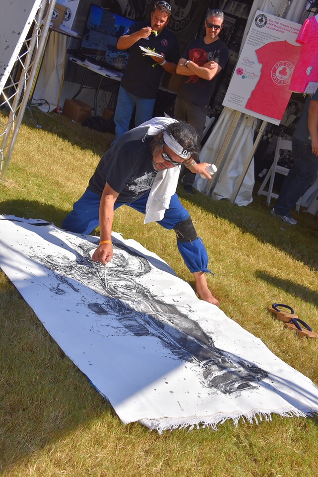 This artist paints with chopsticks. His work was for sale in the swap meet