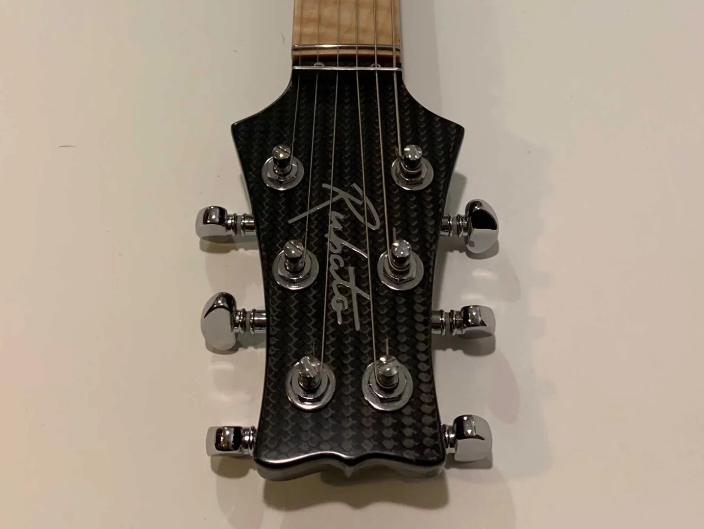 The carbon fiber head is home to Grover locking tuners and an ultra-low string guide