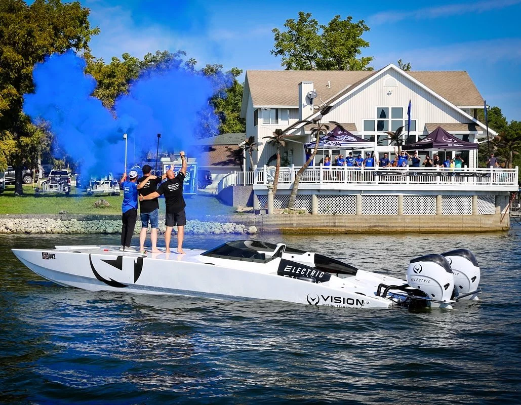 The team celebrates after setting a new speed record for an electric boat