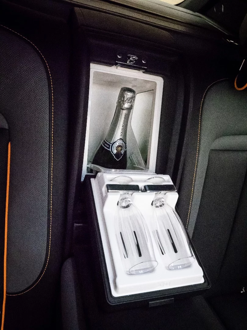 Rolls-Royce Cullinan: between the rear seats in the four-seat model, there's a champagne fridge. It's perfectly legal to have open bottles of alcohol in a car in the UK. How about that.