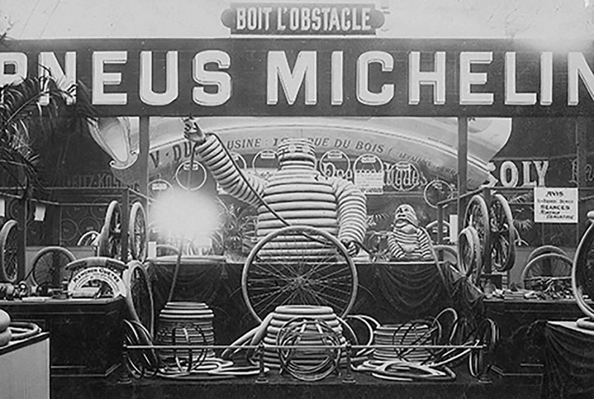 The first public appearance of Bibendum, the Michelin Man occurred on June 15, 1898, the opening day of the Exposition Internationale d'Automobiles at Jardin_des_Tuileries (Tuileries Gardens) near the center of Paris. This is a photograph from the Michelin archives of the stand on that momentous occasion. Note the prominent Michelin motto "boit l'obstacle" (drink the obstacle) and the concentration on bicycle tires. There were very few cars on the roads in Europe at the time, and in the late eighteenth century, the bicycle had already become the first new personal transport concept since the horse and cart. The horse and cart (nee chariot) has been one of the great enabling technologies of history. It came into being with the invention of the spoked wheel, which was largely enabled by the metallurgical advances of the bronze age, and it served as the primary means of transport for all civilizations from 2500BC until
