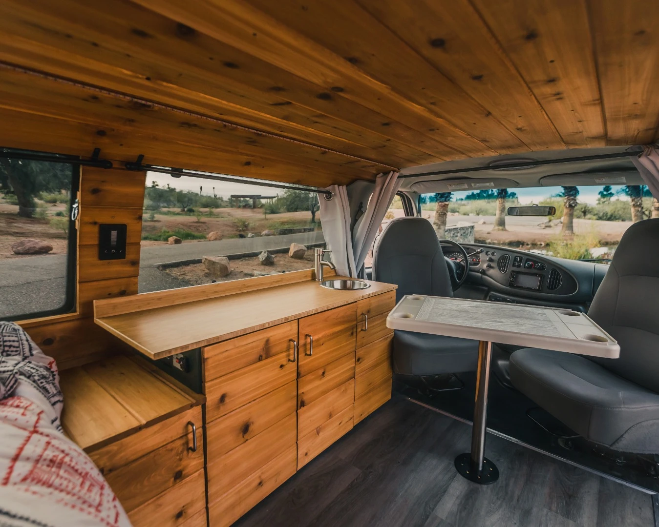 Boho keeps the interior very simple and clean - instead of a kitchen packed with equipment, it has a long bamboo counter and electric-pumped sink, relying on a portable stove and rear slide-out counter for cooking