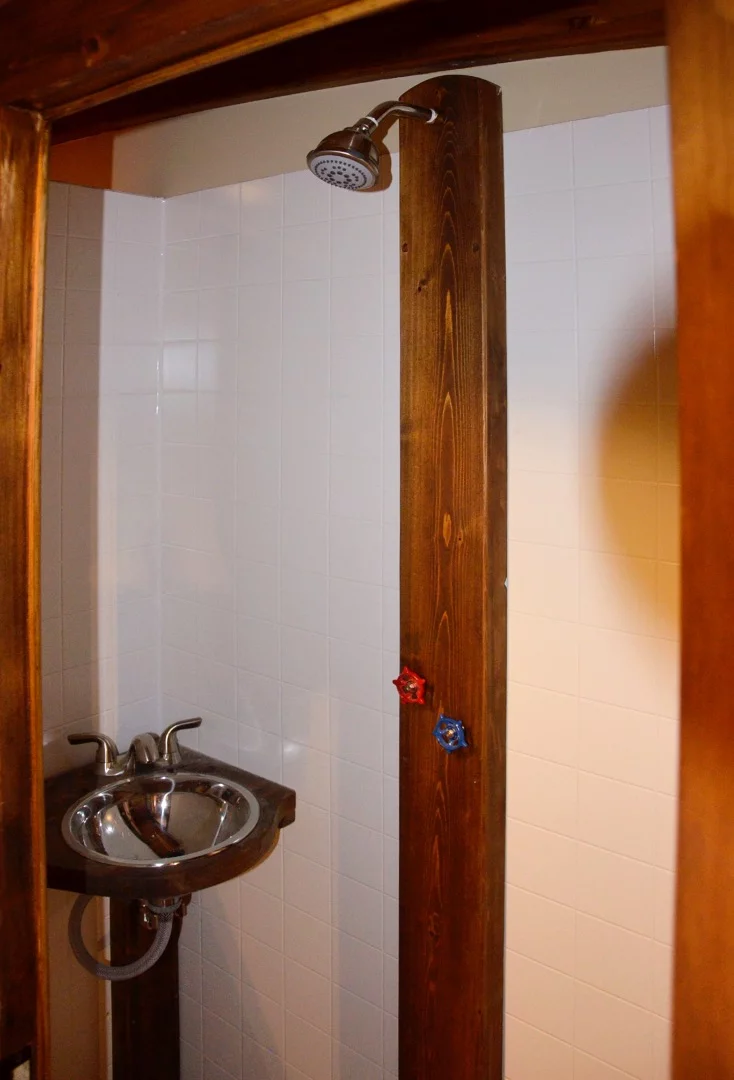 Le Koroc's bathroom includes sink, shower, and toilet