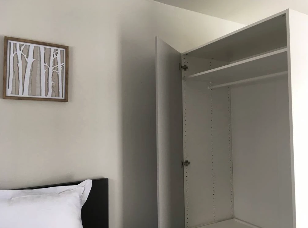 The Intellectual Tiny Home's bedroom includes some storage space