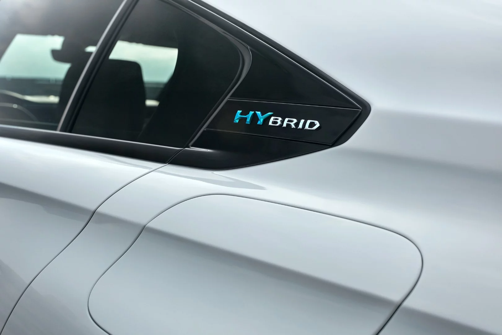 The charging port is located just underneath the "HYbrid" logo on the Peugeot 508